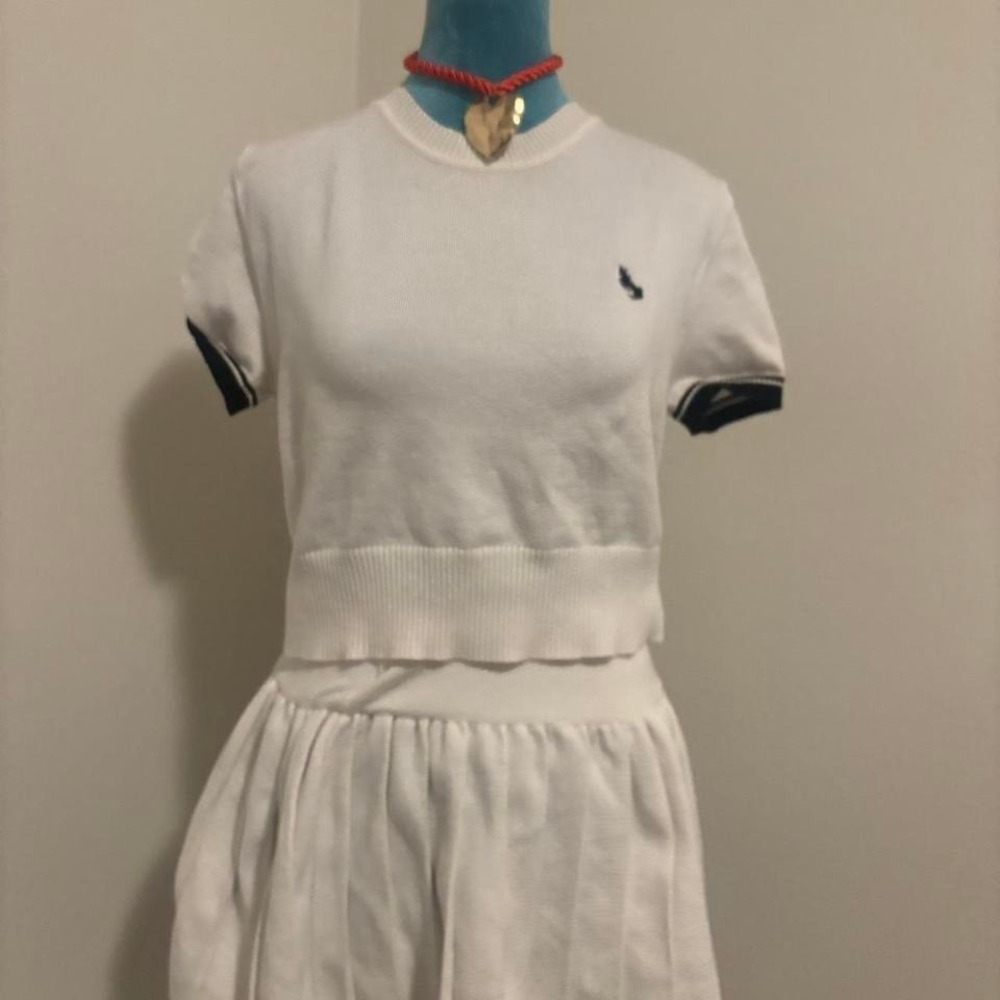 White polo shirt with navy blue stripes‎ and embroidered logo